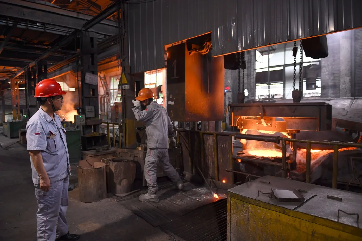 Casting workshop — induction furnace pour and sand moulding line