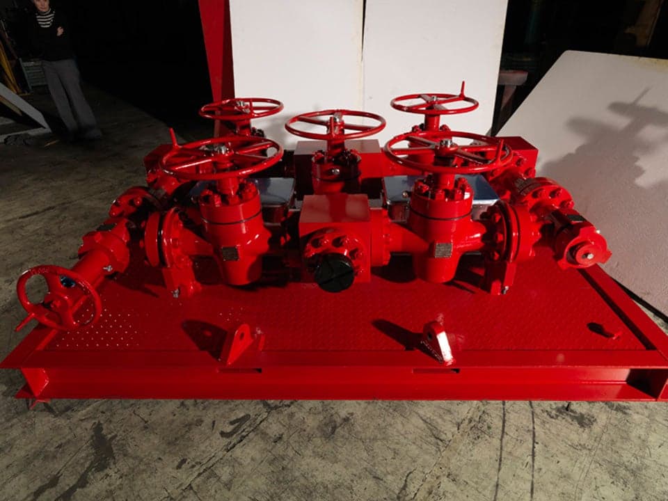 Red API 6BX 10K flanged choke manifold on a skid with gate valves