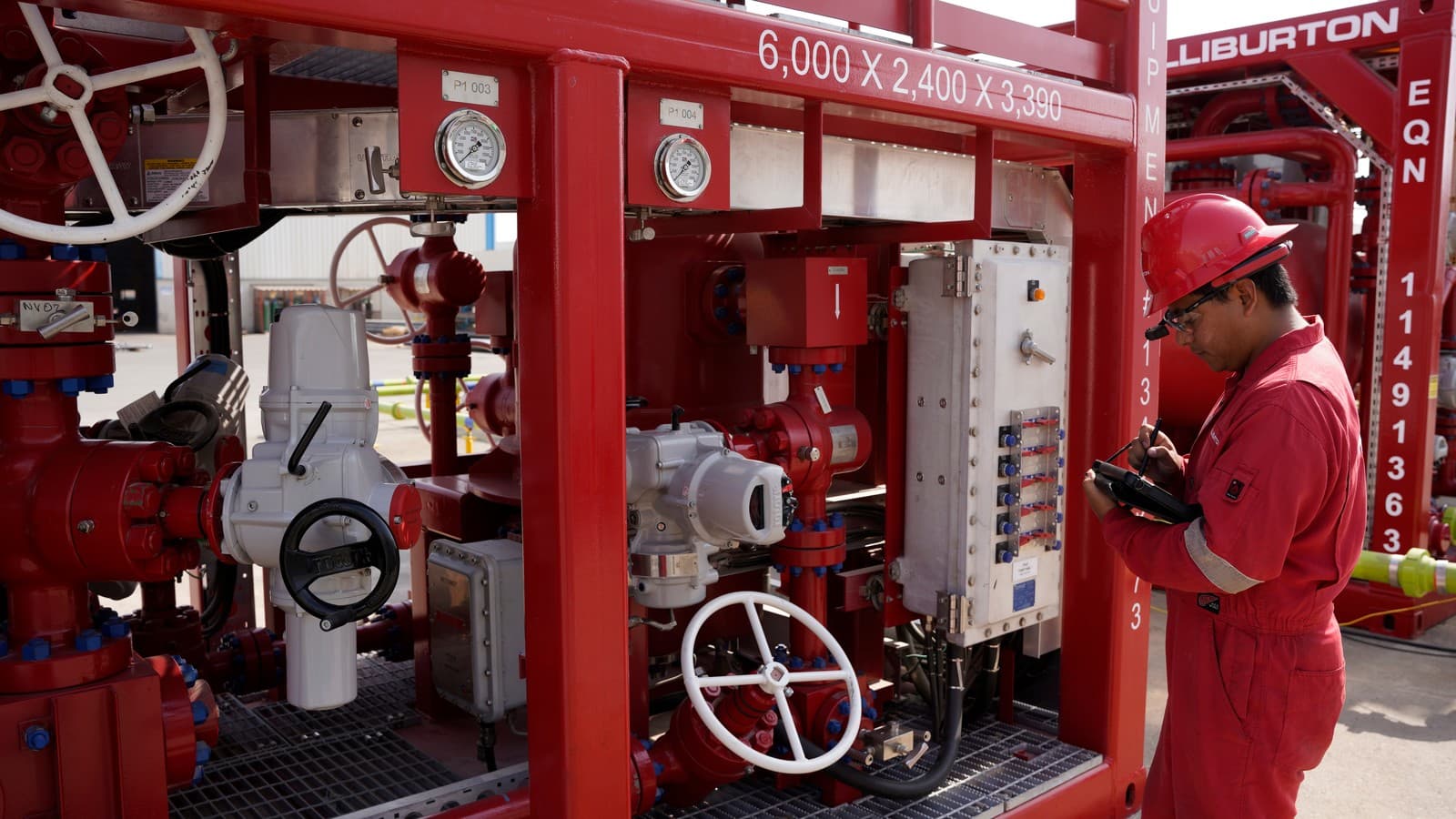 Operator at a red single-stage choke manifold control skid, 1502, 10,000 psi sour