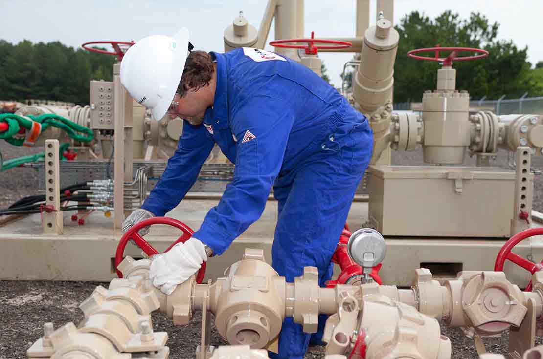 Technician working on a single-stage choke manifold, 1502, 15,000 psi