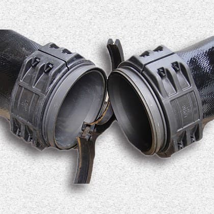 Male and female large-bore lay flat couplings fitted to black hose ends, ready to join