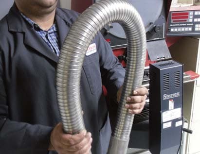 Technician bending a carbon steel ball-joint armour hose guard