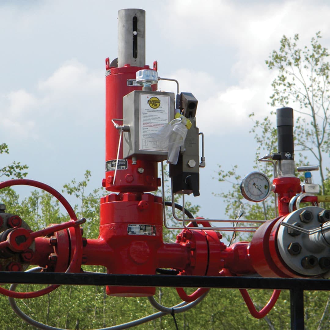 Red hydraulic fail-close gate valve with actuator installed on a wellhead