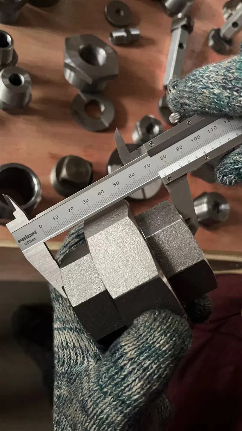 Vernier caliper measuring across the flats of a machined hex fitting