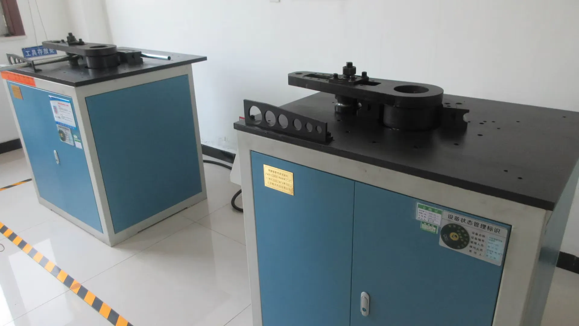 Steel tube bending and flattening test rig